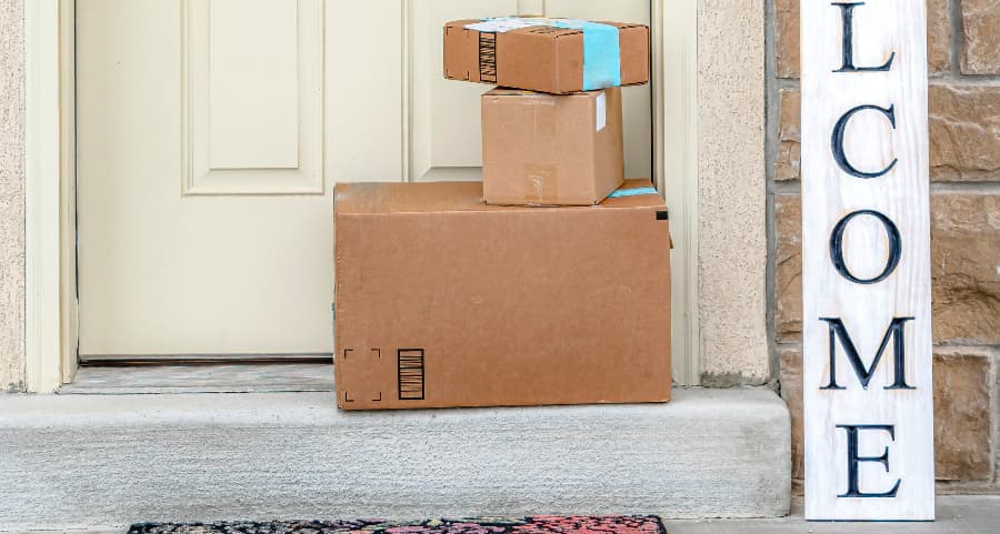 Boxes by the door of a residence with a welcome sign in Allentown